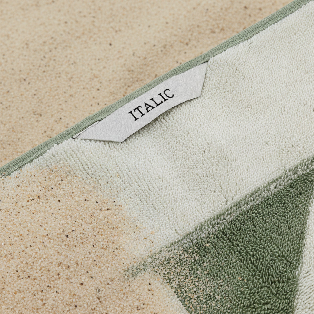 Green and white textured towel with 'Italic' label
