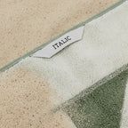 Green and white textured towel with 'Italic' label