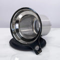 Stainless steel mesh tea strainer on a white background