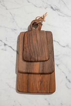 Set of 3 assorted walnut Une Vie Nomade rectangular cutting boards.