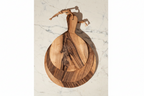 Three round Une Vie Nomade paddle style walnut cutting boards on a white marble surface.