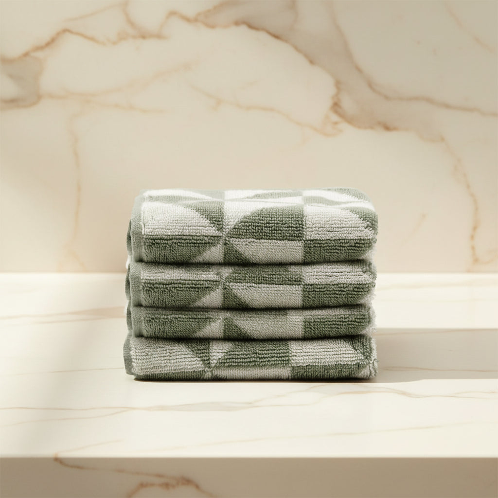 Stack of green checkered towels on a light background