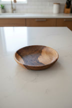 One large Une Vie Nomade walnut bowl shaped tray on white kitchen countertop.