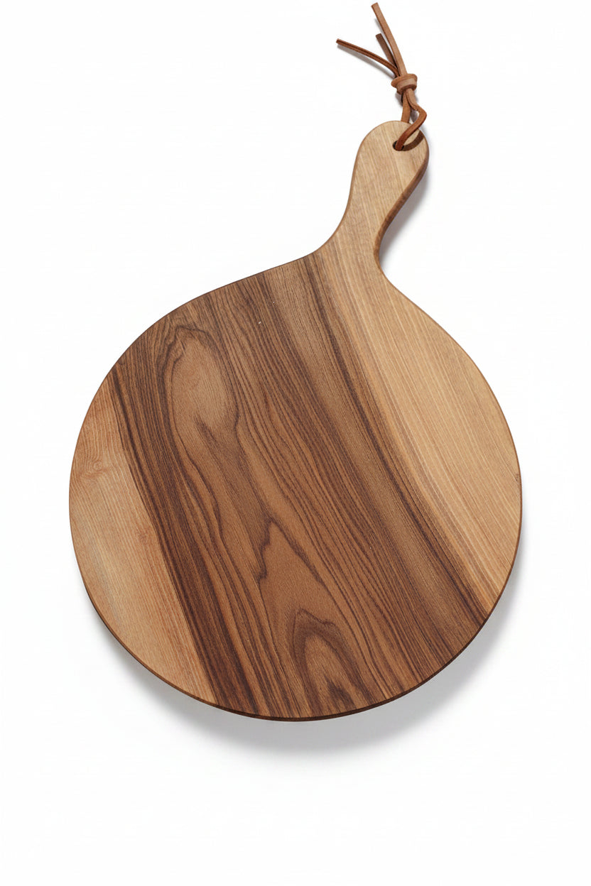 Large round Une Vie Nomade walnut cutting board on a white sruface.