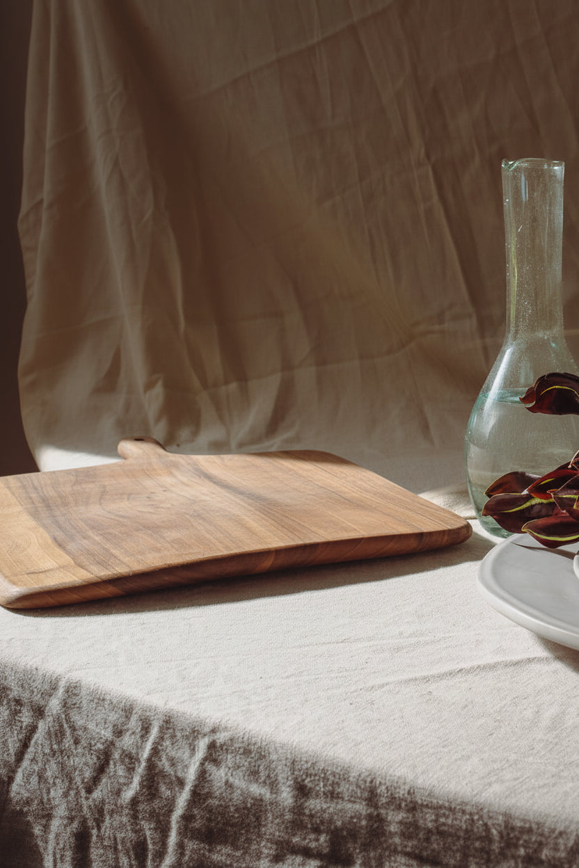 A large rectangular paddle-shaped Une Vie Nomade cutting walnut cutting board on a neutral background.