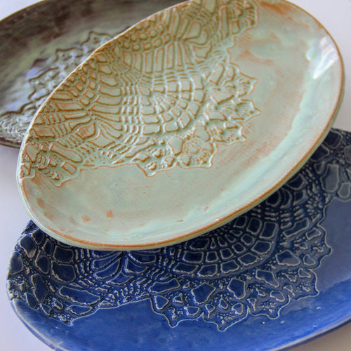 A close-up of white, green, a blue group of platters.