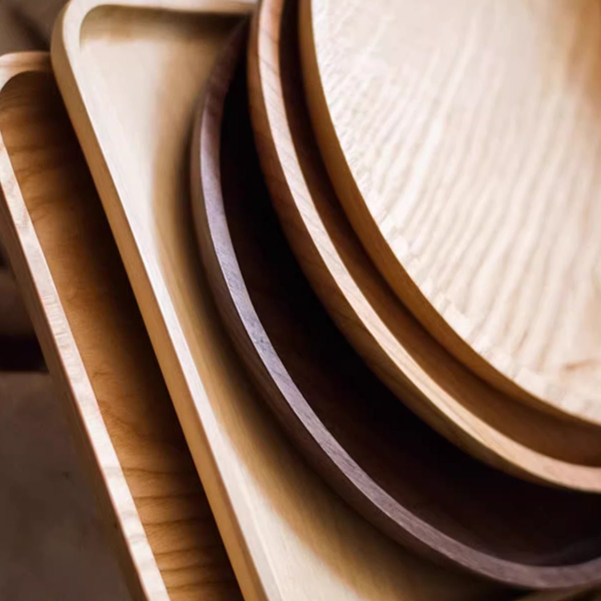 Stack of wooden trays with different finishes