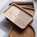 Set of wooden trays on a white surface.