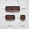 Wooden trays of different sizes with measurements on a white background