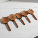 Set of 5 assorted Une Vie Nomade serving walnut spoons one a white background.
