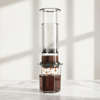 AeroPress Clear XL coffee and espresso maker on a light background.