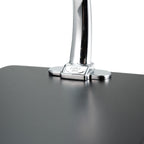 Close-up of a polished chrome metal stand for a Yama Glass Silverton Pour Over with a black stand against a white background.