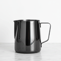 Barista Basics 20 oz. Milk Frothing Pitcher Black on a light surface.