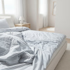 blue and white striped bedding in a light room.