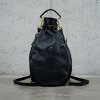 Remington Black Italian Leather backpack on a concrete surface.