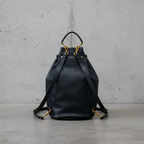 Remington Italian Leather Backpack in Black, back view with straps, concrete background