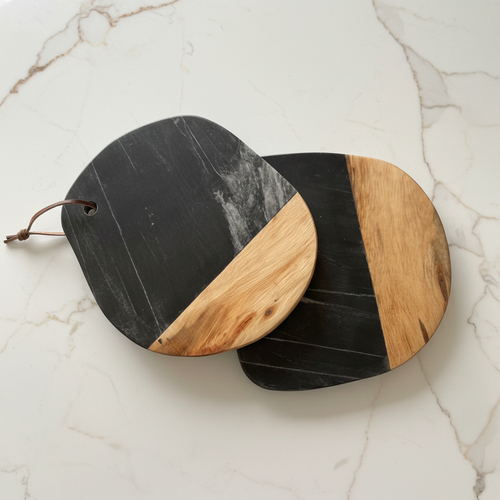 Two Black Marble & Wood Cheese Boards – with leather strap on a light surface.