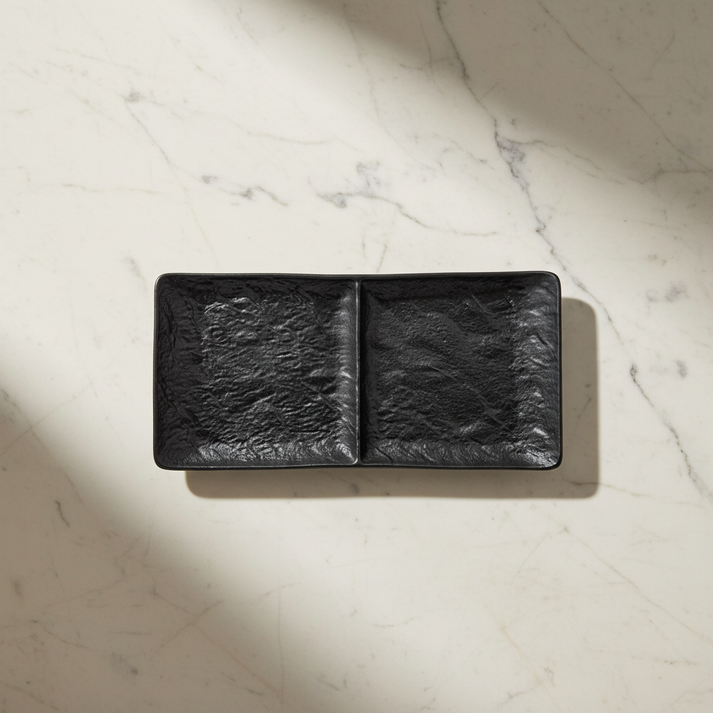 Black two-section dish with soft natural shadow