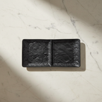 Black two-section dish with soft natural shadow