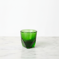 A emerald colored Vero espresso glass 3 oz. on a light background.