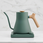 Fellow Stagg EKG Pro stovetop kettle Smoke Green w/ Maple on a light background