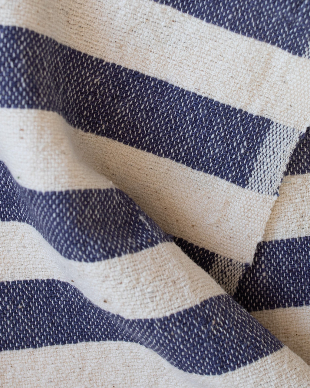 A close up view of a blue and white towel, folded.