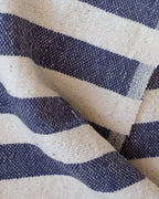 A close up view of a blue and white towel, folded.
