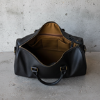 James Leather Duffle Bag in Black, interior of bag view, concrete background