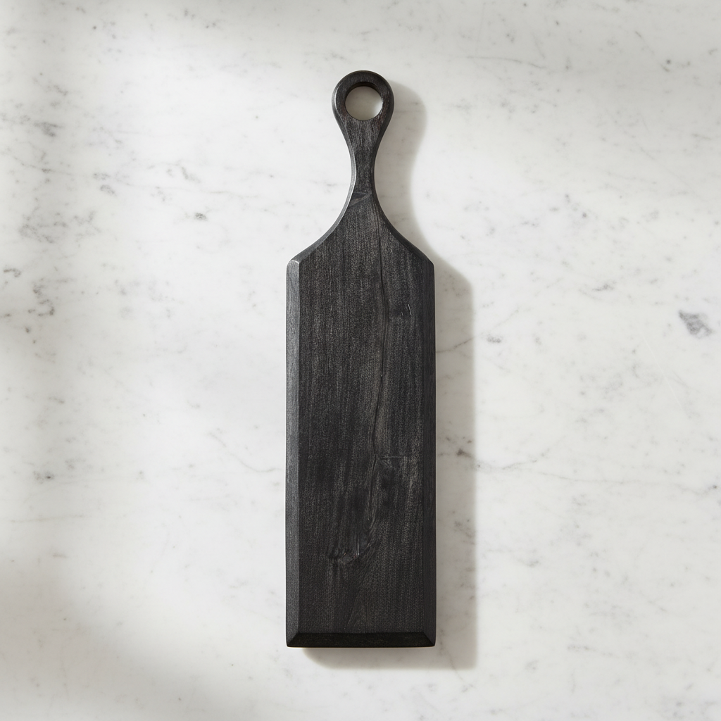 Midnight Black Paddle Tray with handle on a light surface.