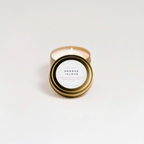 Orange + Clove Travel Tin on a white surface.