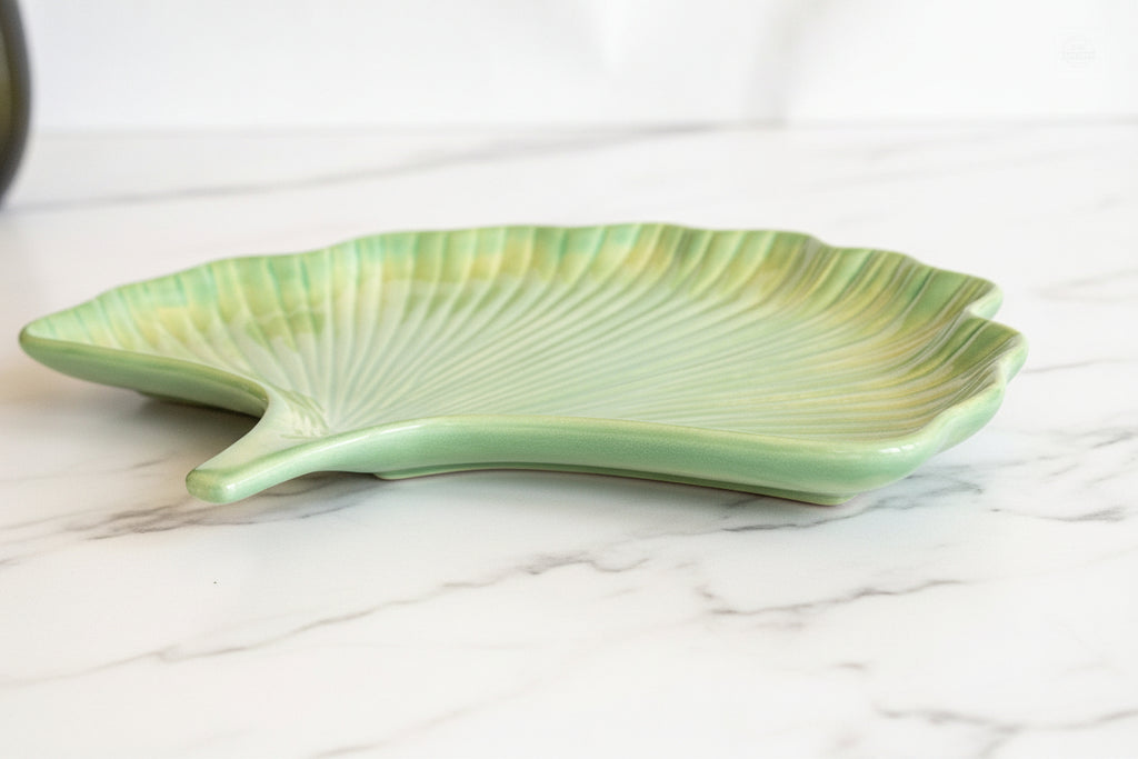 Prodigal Pottery ginkgo leaf plate on a white marble countertop.