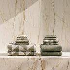 Stacks of green towels on a marble  table with a light background