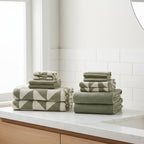 Stacks of green towels on a bathroom vanity.