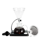 Yama silverton coffee brewing apparatus with glass carafe and black base on a white background