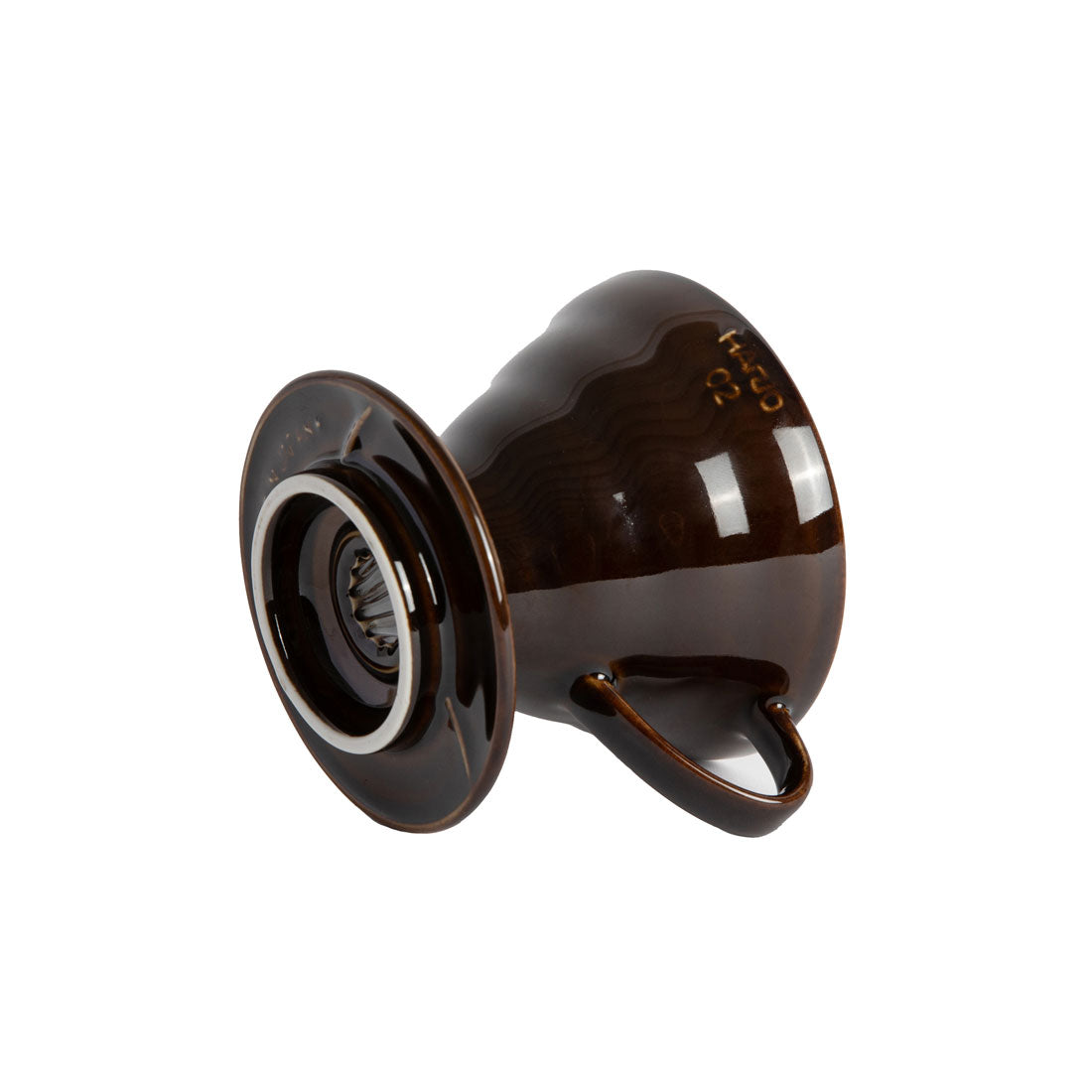 Side view of a brown colored coffee pour over dripper with a white background.