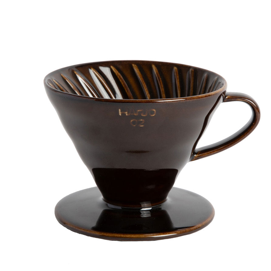 Brown colored coffee drip pour over on a white background.