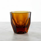 Vero Cappuccino Glass (6oz) - Amber, on a white marble surface.