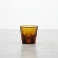 Vero Espresso glass in amber color on a light background. 
