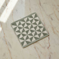 geometric patterned wash cloth on a light surface.